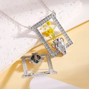 Macro detail of vintage silver photo frame necklace with real yellow dried flowers inside