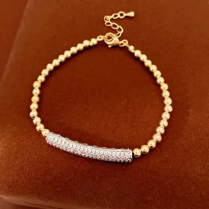 Elegant adjustable gold beaded bracelet with a micro-pave zircon curved bar detail