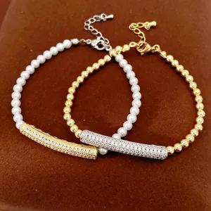 Detail view of gold and silver zircon-encrusted bamboo bar with pearl bead bracelets