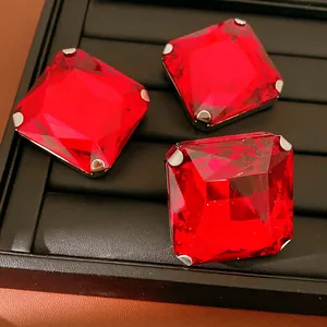 Macro view showing the brilliant facets of three red square rhinestone stud earrings