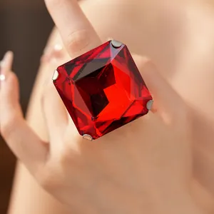 Detailed macro view of a large square red crystal ring in a classic silver prong setting