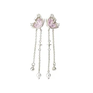 Elegant butterfly drop earrings with pink zircon, chains, and pearls on white background.