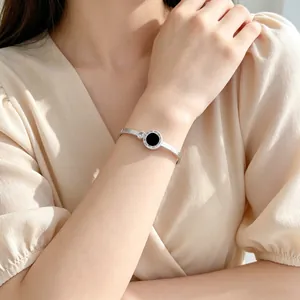Minimalist silver stainless steel bangle with black Roman numeral charm and zircon