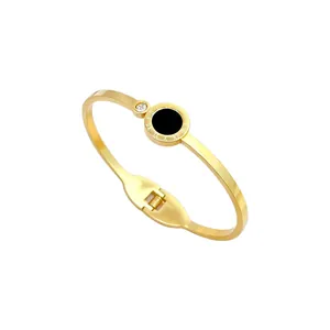 Gold titanium steel bangle with Roman numerals, black inlay, and zircon detail.