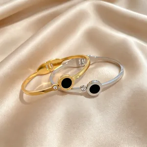 Macro view of gold and silver Roman numeral bangles on elegant satin background