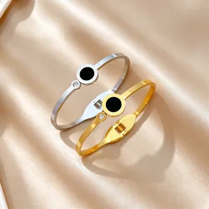 Detail view of Roman numeral stainless steel bangles with black inlay and zircon