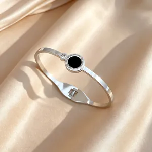 Detailed shot of silver titanium steel bangle with Roman numerals and zircon stone