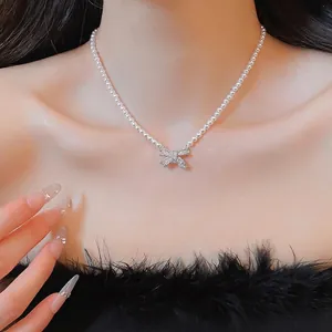 Elegant 18k gold plated pearl necklace featuring a sparkling zircon bow pendant