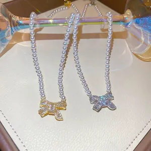Elegant 18k gold plated pearl necklace with a sparkling zircon bow pendant
