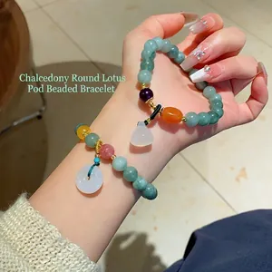 Elegant chalcedony beaded bracelet with lotus pod and white donut pendant charms