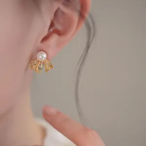 Elegant 18K gold plated bow stud earrings featuring a lustrous pearl and zircon accents