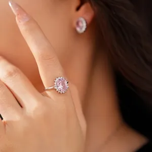 Elegant luxury pink oval zircon ring and earring jewelry set shown on a female model