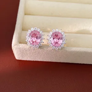 Elegant oval pink zircon stud earrings with crystal halo in a beige jewelry box