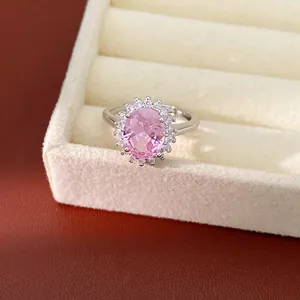 Elegant pink oval zirconia ring shown in detail within a cream jewelry display box