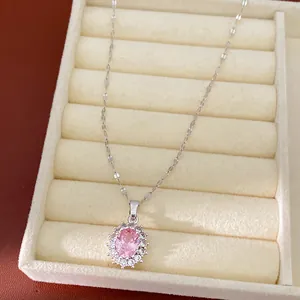 Close-up of elegant pink oval zircon pendant necklace presented in a velvet jewelry box