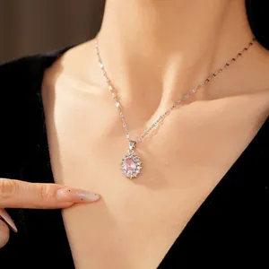 Detailed view of an elegant silver necklace with an oval pink zircon pendant on a model