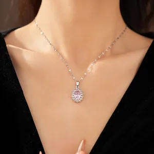 Elegant silver necklace featuring an oval pink crystal pendant surrounded by clear zircons.