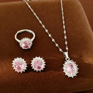 Detailed view of luxury oval pink zircon jewelry set with earrings, ring and necklace