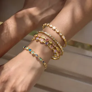 Close-up of 18K gold-plated stainless steel bracelets with multi-colored cubic zirconia