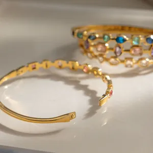 Macro view of gold stainless steel bangle with multi-color zircon stones detail