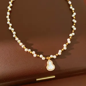Detailed close-up of 18k gold plated gourd pendant necklace with pearls and zirconia