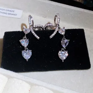 Sparkling zircon bow and heart clip-on earrings for non-pierced ears in silver finish