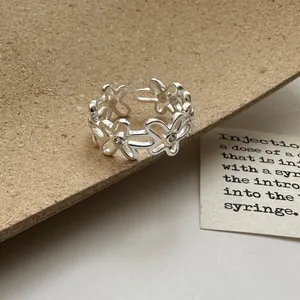 Detailed macro view of an exquisite silver flower hollow-out open ring with zircons