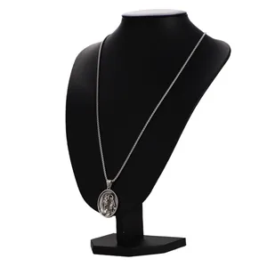 Classic silver religious oval relief pendant necklace displayed on a black neck bust