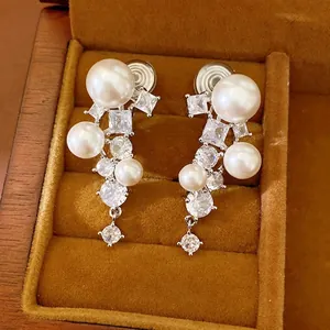 Elegant silver-toned clip-on earrings with large pearls and sparkling cubic zirconia stones