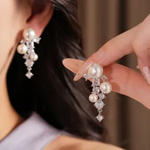 Detailed close-up of elegant pearl and cubic zirconia drop earrings for a luxury look