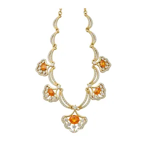 Elegant gold fan-shaped necklace with orange gemstones and sparkling crystals