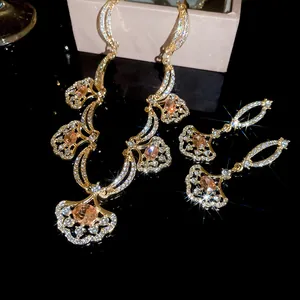 Detailed view of the sparkling diamond fan-shaped pendant necklace and earrings set