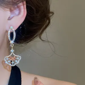 Detailed view of elegant luxury rhinestone fan-shaped dangle earrings in palace style