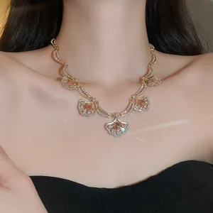 Elegant gold necklace with sparkling rhinestone fan pendants in a luxurious palace style