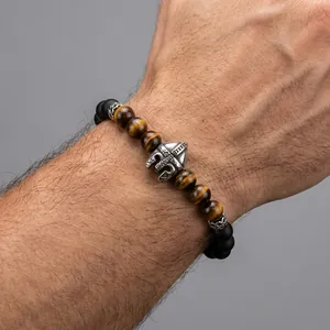 Close-up detail of Spartan helmet bead on tiger eye and matte black onyx bracelet