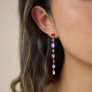 Detail view of elegant stainless steel tassel earrings with colorful geometric zircons.
