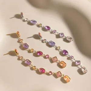 Detailed view of stainless steel tassel earrings featuring vibrant multi-colored geometric zircons.