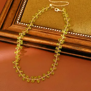 Elegant detail of handmade olive green glass bead necklace with 14k gold plated chain link