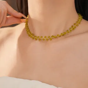Detailed view of 14k gold plated necklace featuring translucent green glass beads jewelry