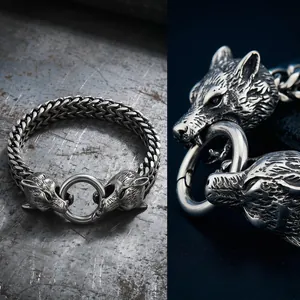 Detailed macro view of intricately carved double wolf heads on a Viking steel bracelet