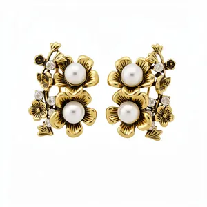 Elegant vintage gold floral stud earrings featuring white pearls and sparkling crystals
