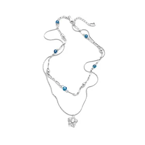 Elegant double-layer silver necklace with blue beads and a sparkling star pendant