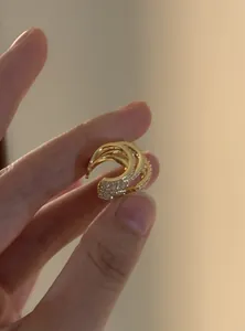 Macro detail of a sparkling CZ multi-layered gold ear cuff for non-pierced ears