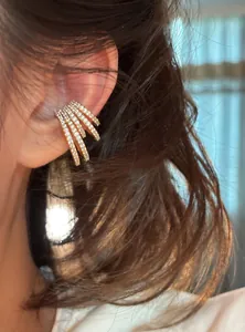 Close-up of four-layer zircon ear cuff worn on model's ear for elegant look