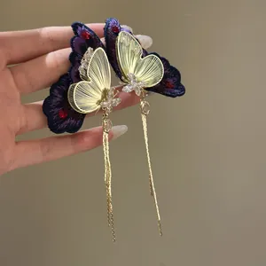 Elegant purple embroidered butterfly earrings with gold tassels and zircon detail