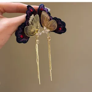 Detailed view of elegant gold butterfly tassel earrings with purple embroidery and zircon stones