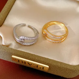 Close-up detail of 18k gold plated open rings with sparkling zircon in a jewelry box