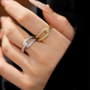Detailed close-up showing elegant 18k gold plated geometric rings with zircon on a hand