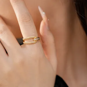 Detailed view of an 18k gold plated geometric open ring with cubic zirconia on hand