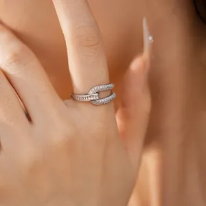 Close-up of a geometric hollow open ring with sparkling cubic zirconia on finger